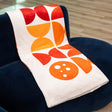 PragerU throw blanket with soft fabric and printed logo, showcasing a cozy and stylish home accessory.