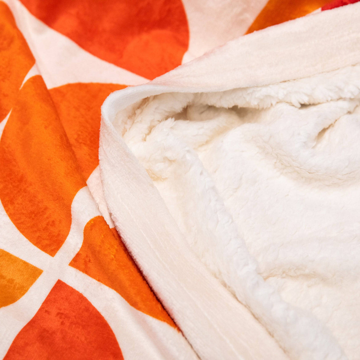 PragerU throw blanket with soft fabric and printed logo, perfect for cozying up on the couch or bed.
