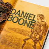 Book cover for "Trailblazers of America: Heroes of the Frontier" by PragerU, featuring a historical frontier scene.