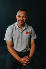 PragerU polo shirt in sport grey, men's size S, casual fit, featuring the PragerU logo on the chest.