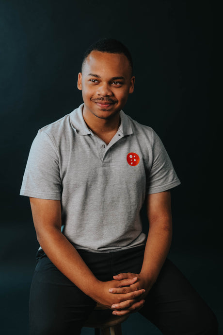 PragerU polo shirt in sport grey, men's size S, featuring the PragerU logo on the chest.
