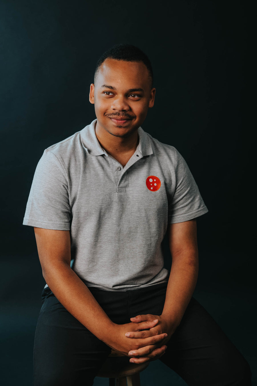 PragerU polo shirt in sport grey, men's size S, casual fit, featuring the PragerU logo on the chest.