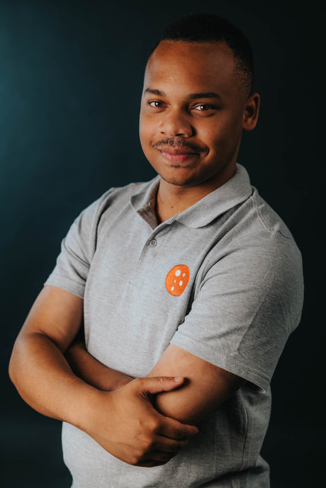 PragerU polo shirt in sport grey, men's size small, made of soft cotton, featuring the PragerU logo on the chest.