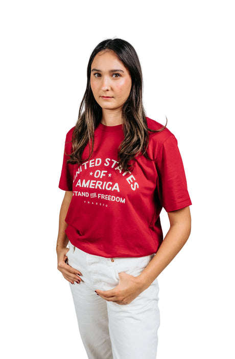 Beige PragerU Stand for Freedom T-shirt with logo, shown on a black background, casual fit, soft cotton fabric.
