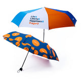 PragerU umbrella set with "Life, Liberty & Happiness" slogan and logo, featuring two black umbrellas with colorful design accents.