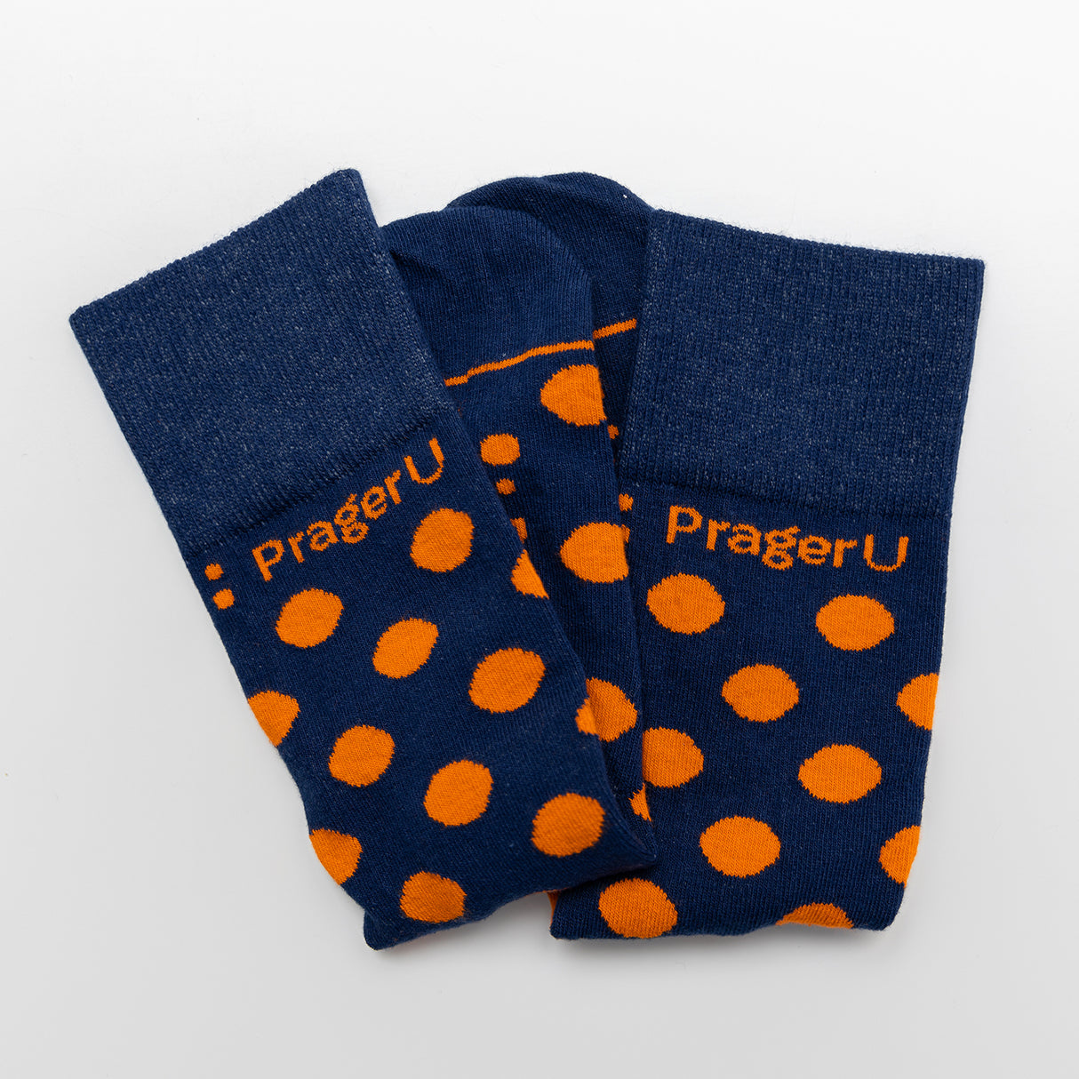 PragerU Dot Socks featuring a pattern of small white dots on black fabric, casual unisex socks with comfortable fit.