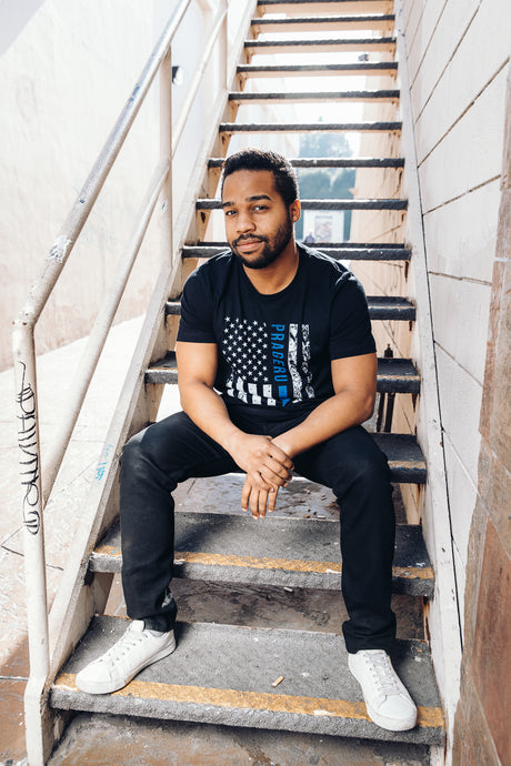 PragerU Thin Blue Line distressed flag T-shirt featuring a blue line design on soft fabric, symbolizing support for law enforcement.
