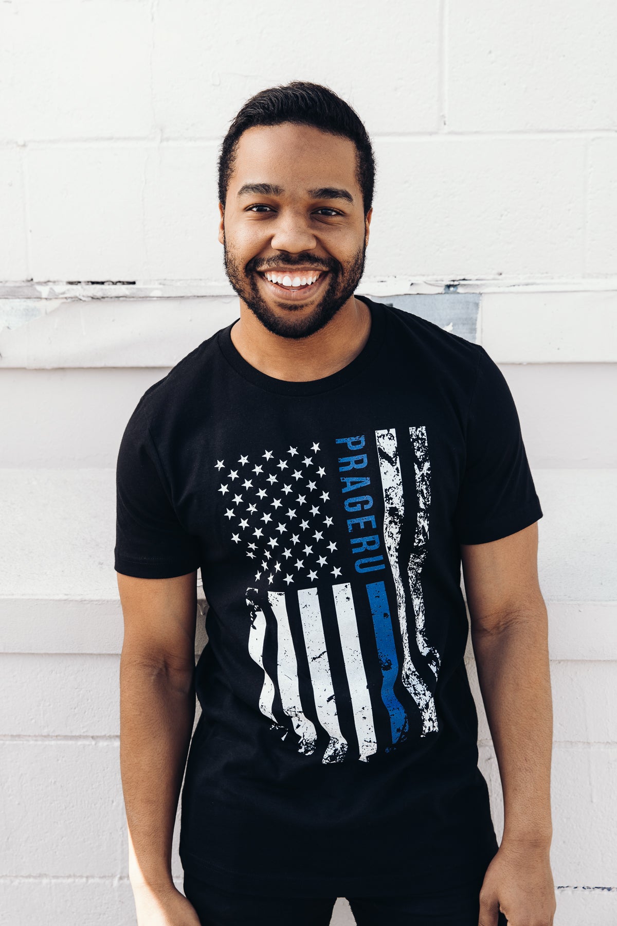 PragerU Thin Blue Line distressed flag T-shirt showing a navy blue flag with a single blue stripe and distressed design.