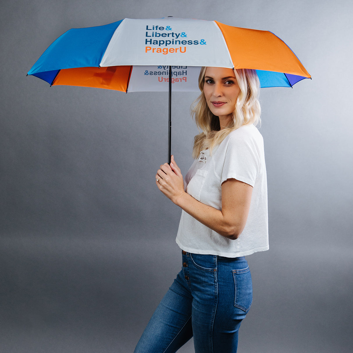 PragerU umbrella set featuring quotes about life, liberty, happiness, and the PragerU logo on navy blue umbrellas.